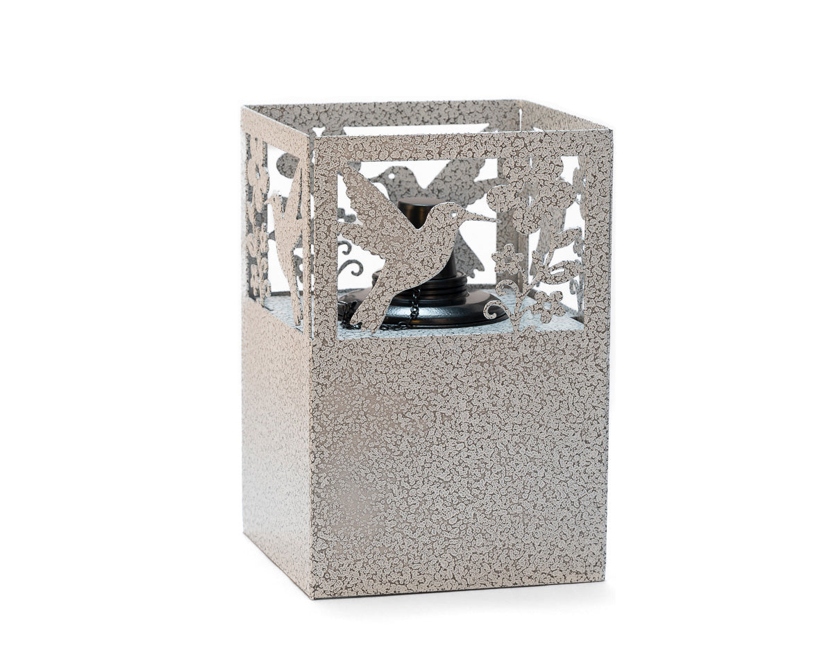 Rustic metal hummingbird tiki torch with floral cutout design, handcrafted outdoor lantern for garden, patio, or yard lighting.