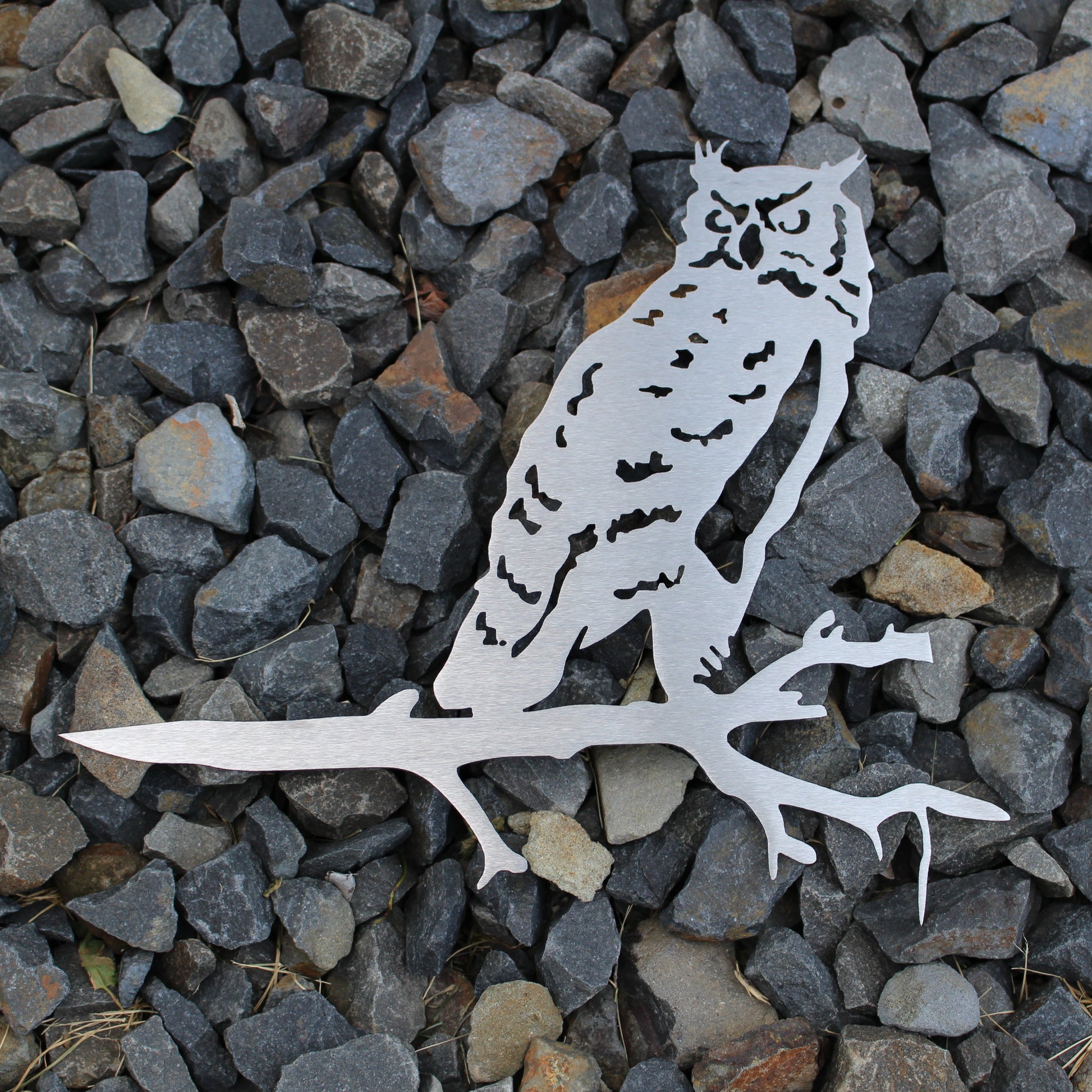 Metal owl tree stake perched on branch, rustic steel garden decoration for outdoor yard or lawn