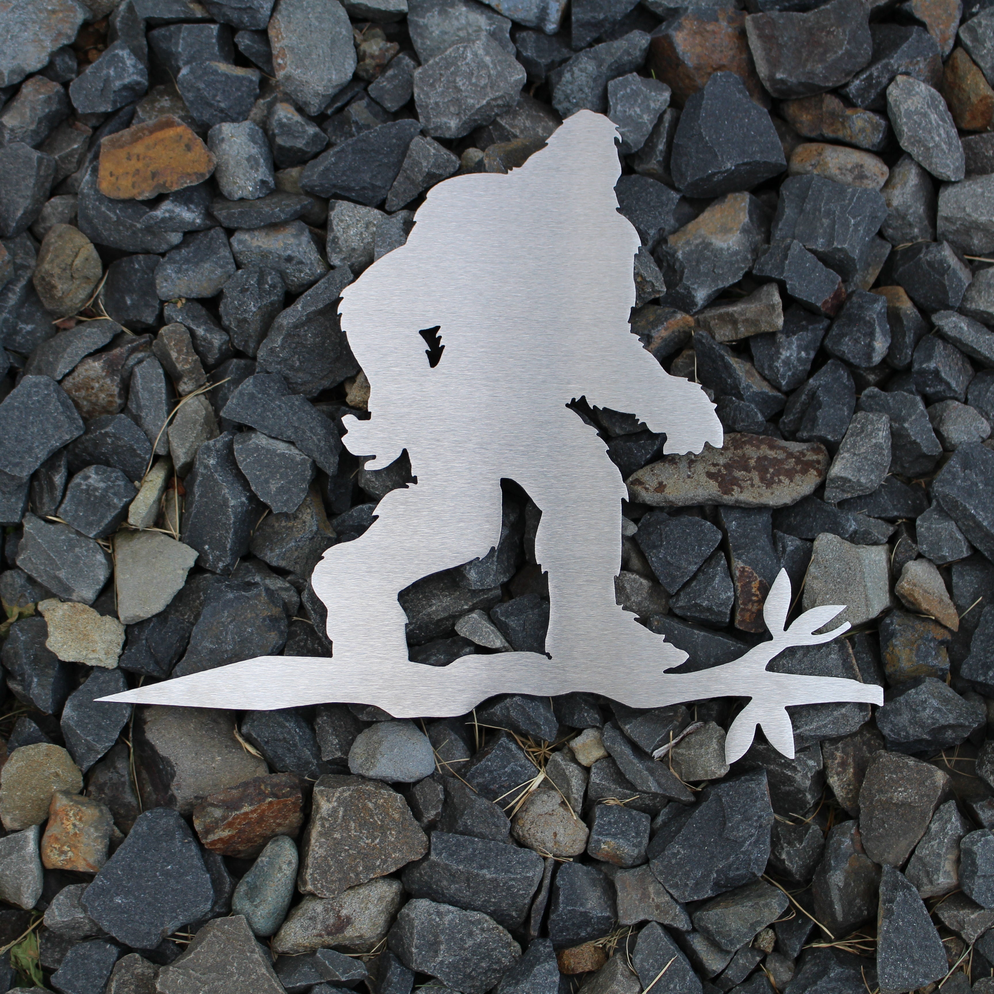 Metal sasquatch tree stake on branch, rustic steel Bigfoot garden decoration for outdoor yard or lawn