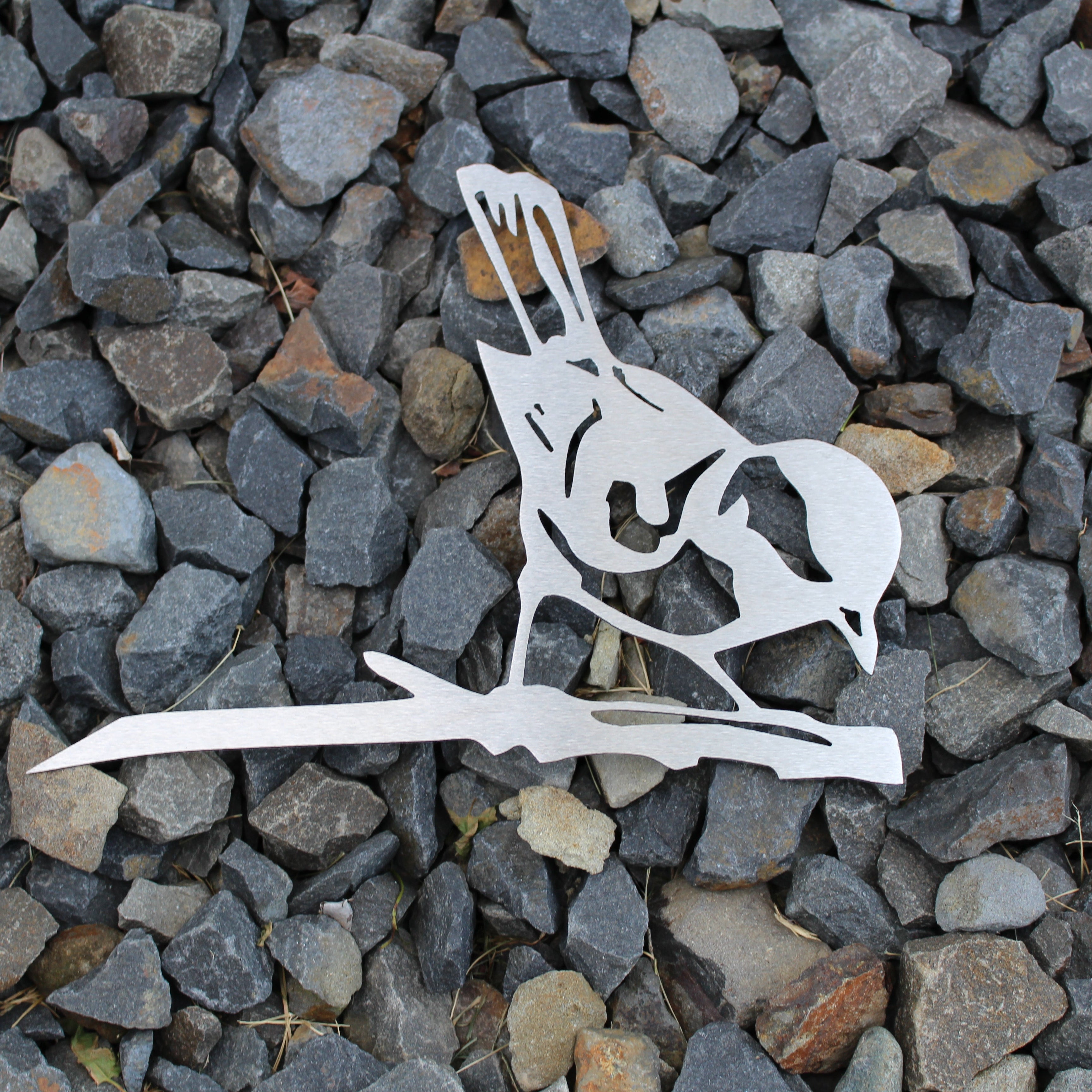 Metal finch bird tree stake perched on branch, rustic steel garden decoration for outdoor yard or flower bed